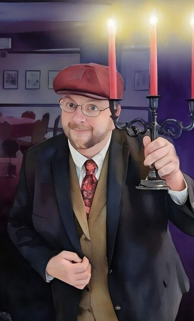 Vince Wilson holding a lit candelabra